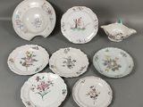 several plates and bowls are arranged on a gray surface