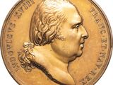 gros plan d'une pièce d'or sur laquelle figure le visage d'un homme