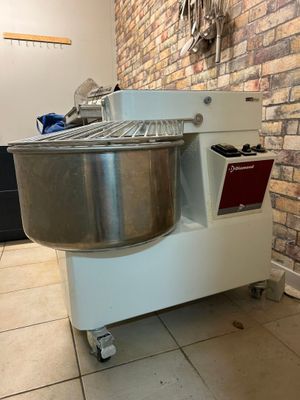 an image of a commercial doughnut machine in a kitchen