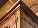 a picture of a wooden cabinet with a metal door handle