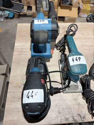 several electric tools are sitting on a table in a workshop