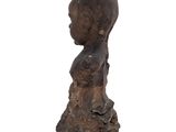 an image of a sculpture of a woman ' s head on a piece of wood