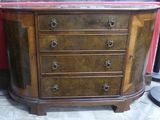 a wooden dresser with a marble top on display