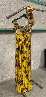dress hanging on a clothes rack in a room with a black couch