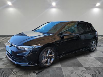 a black car parked in a garage with a checkered floor