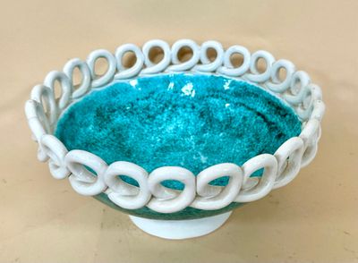 a white bowl with a blue bowl inside of it