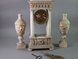 a clock and a pair of scissors on a table