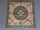 an image of a brown and green square scarf with a skull on it