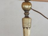 a lamp that is on a table with a lamp shade on it