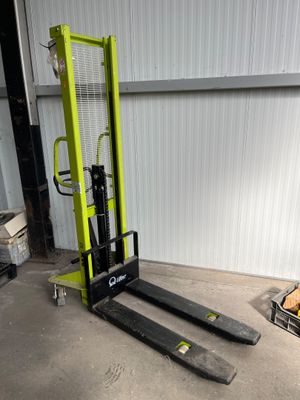 a fork lift truck parked in front of a building