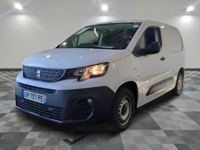 the white van is parked in a large room with a checkered floor