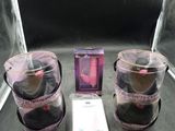 two containers of makeup and a box of lipstick on a table