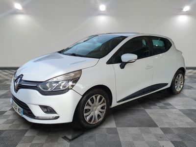 the white car is parked on a checkered tile floor