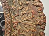 an ornately carved mirror in the corner of a room with a mirror on the wall