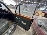a car that is sitting in a garage with its door open