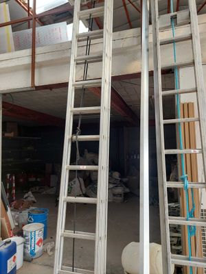 two ladders that are next to each other in a garage