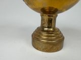 a gold bowl on a gold pedestal on a white background
