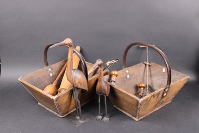 two wooden birds are sitting in a basket on a table