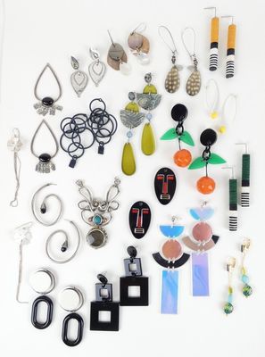 many different pieces of jewelry displayed on a white surface