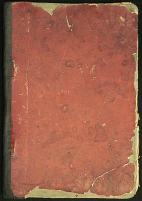 un vieux livre à la couverture rouge posé sur une table