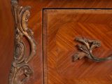 a wooden cabinet with a marble top and a drawer with drawers