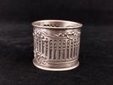 a close up of a silver cup on a black surface