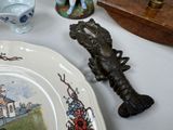 a plate that has a lobster on it next to a plate with a lobster on it