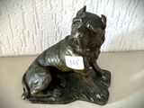 une statue représentant un chien assis sur une table