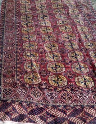 an image of a red and blue rug on a bed
