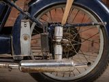 a blue motorcycle with a wooden handlebar attached to it