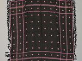 an old black and pink scarf with pink dots on it