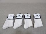four pairs of white socks with black and white stripes on them