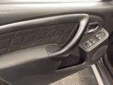 a close up of a car ' s interior with the door handle open
