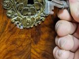 a person that is holding a key in their hand