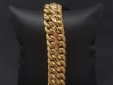 a gold rope bracelet on a black pillow