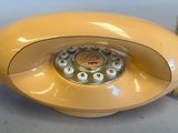 a yellow telephone that is sitting on a table