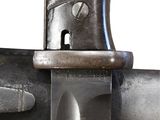 a close up of a knife on a metal pole