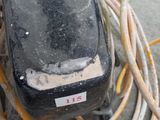 a black cell phone sitting on top of a pile of wires