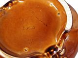 a close up of a brown vase with writing on it