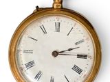 a gold pocket watch with roman numerals on the face