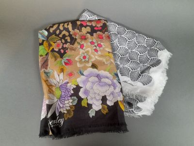 a pair of scarves that are sitting on a table