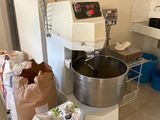 an image of a kitchen with a mixer and bags of food