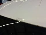 a close up of a car ' s hood with a number plate on it