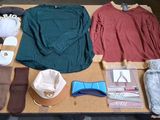 a table with a lot of clothing and accessories on it