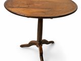 a round table with a wooden top and four legs