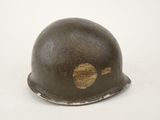 an old helmet is sitting on a white surface with a white background