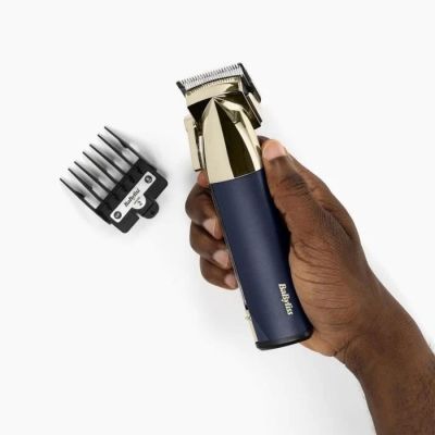 a man that is holding a hair clipper and a comb