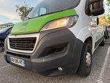 a green and white van parked in a parking lot