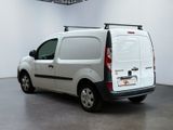a white van parked in a room with a black roof