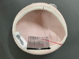 a hair comb and a comb holder on a table